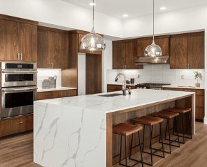 Kitchen in new luxury home with quartz waterfall island