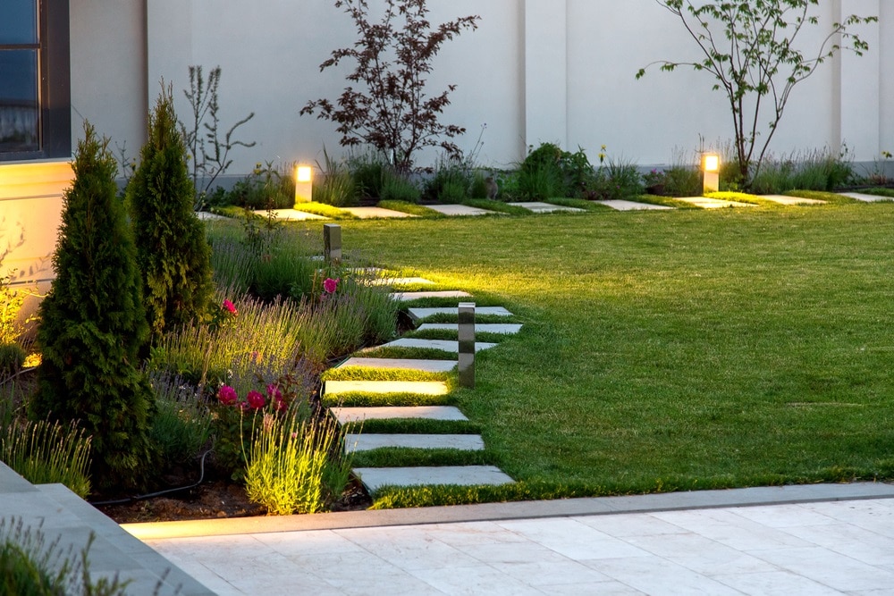 marble walkway of square tiles in the evening with a garden lighting