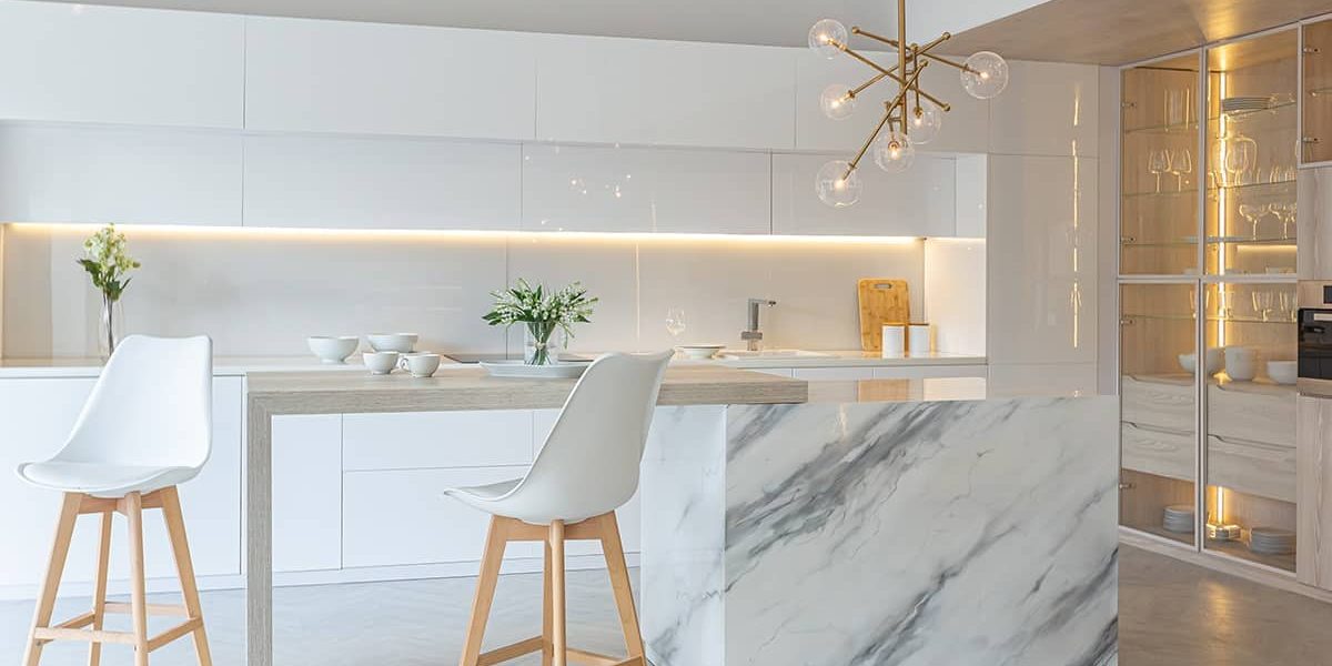 luxury interior design of modern trendy snow white kitchen in minimalistic style with island and two bar stools